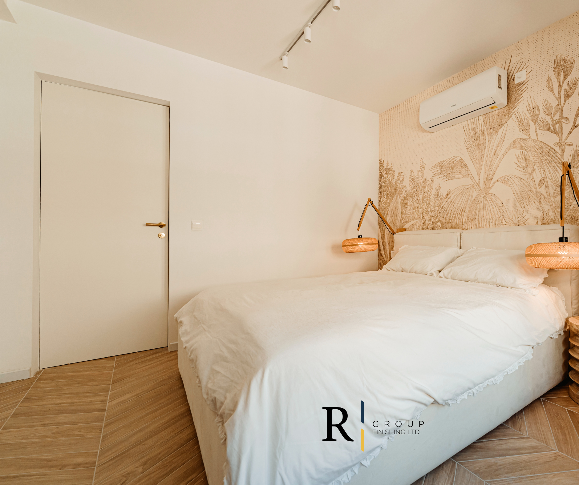 Boho bedroom interior with white door and herringbone floor by R Group Finishing