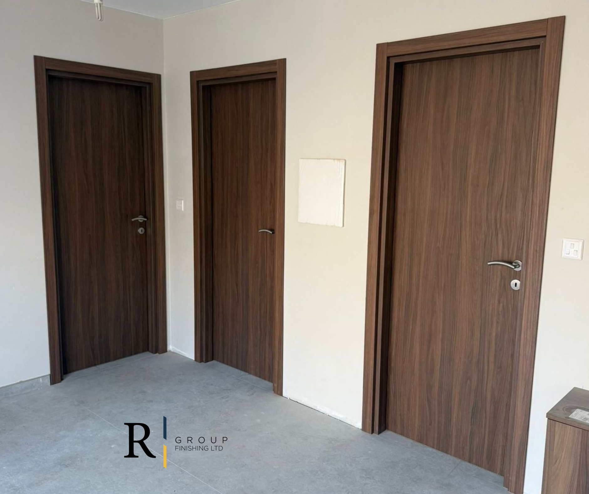 Dark walnut laminated internal doors fitted in apartment by R Group Finishing