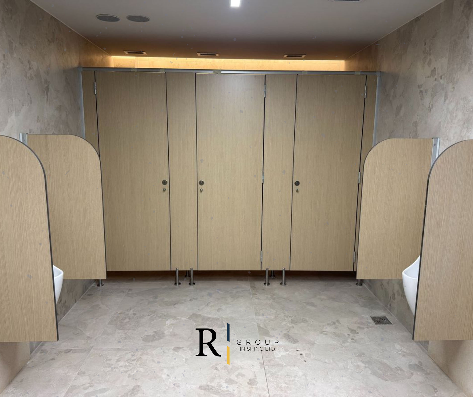 HPL bathroom partition cubicles in light oak finish by R Group Finishing